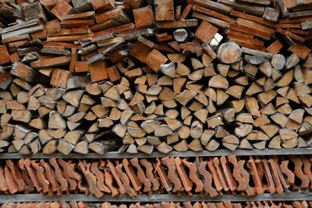 Wood and tiles piled alongside a farm in Stilluptal